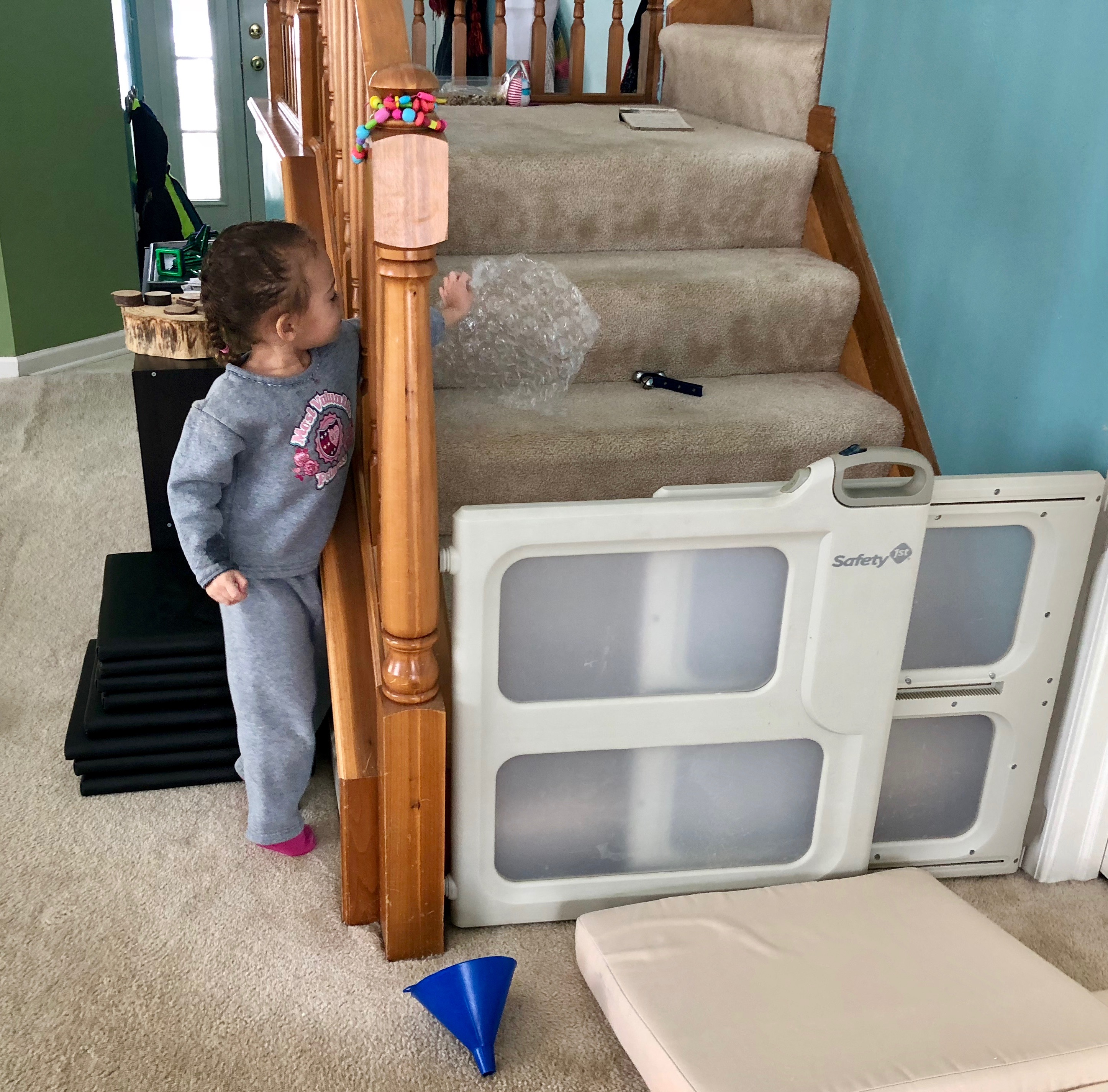 girl trying to grab bell with bubble wrap