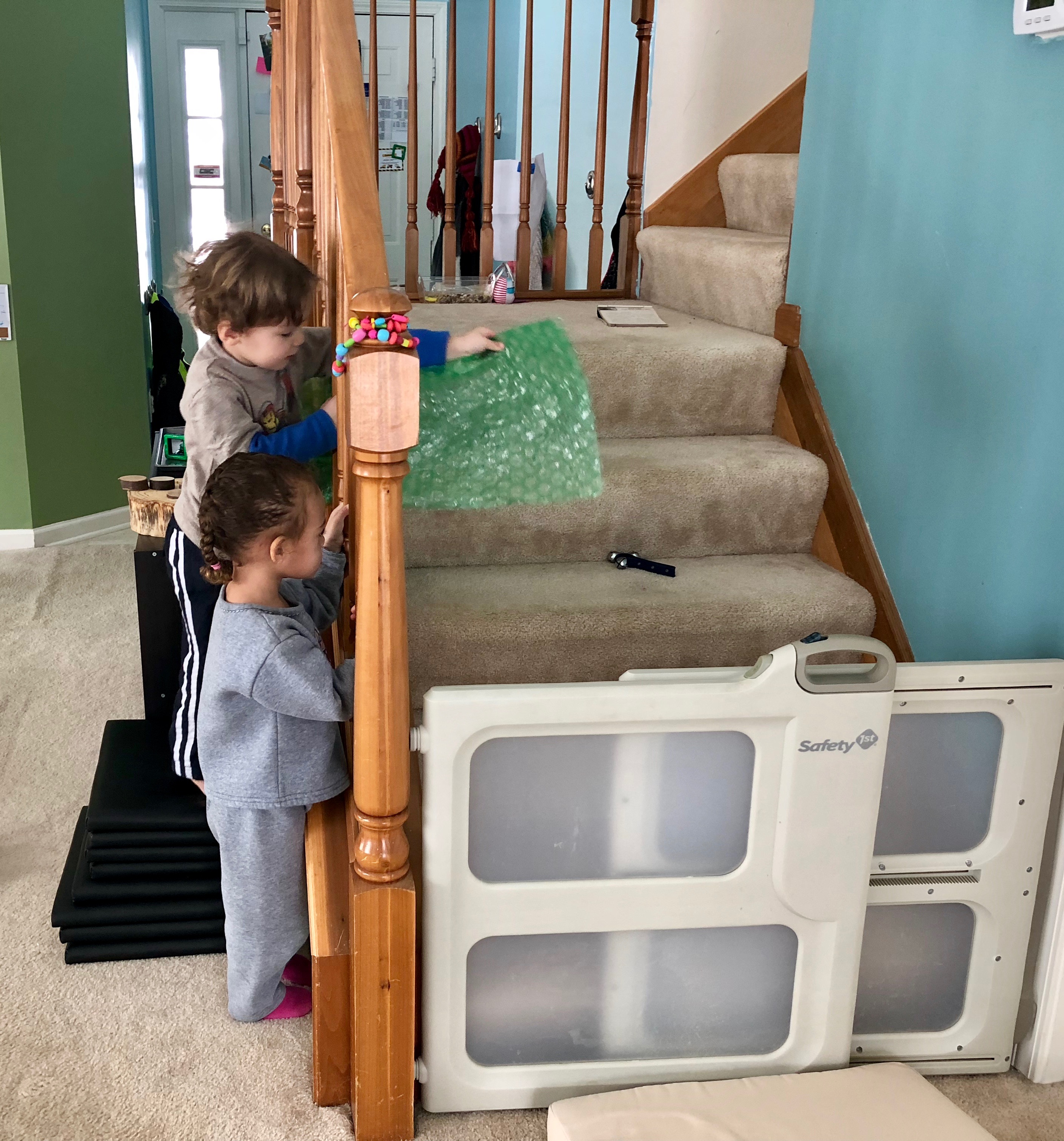 boy trying to reach bell with a longer piece of bubble wrap