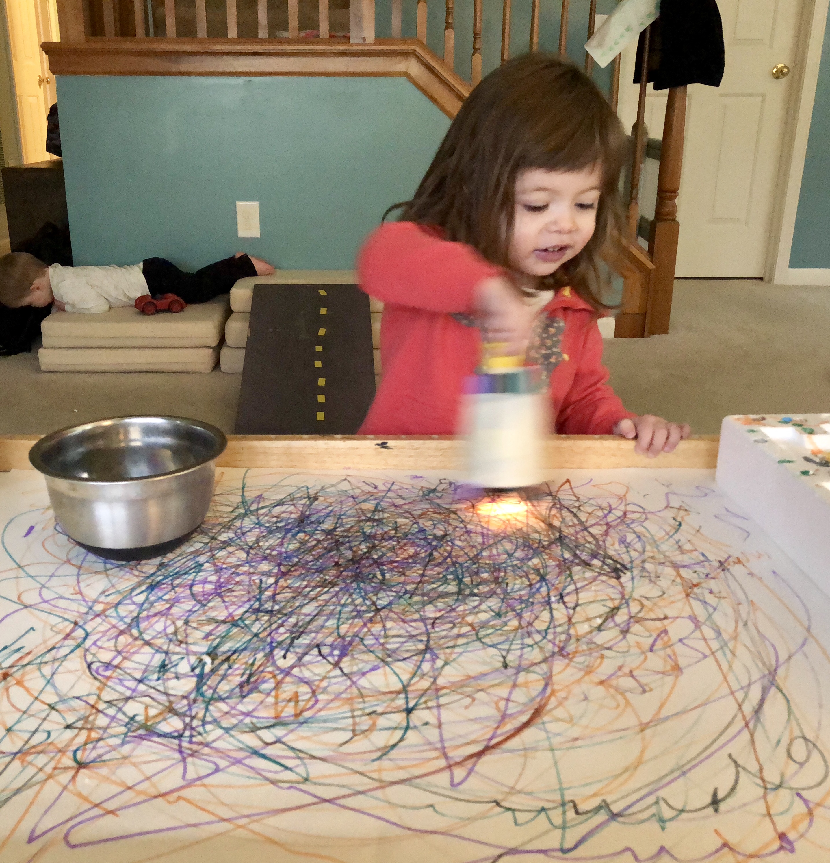 girl coloring with a marker attached to a flashlight