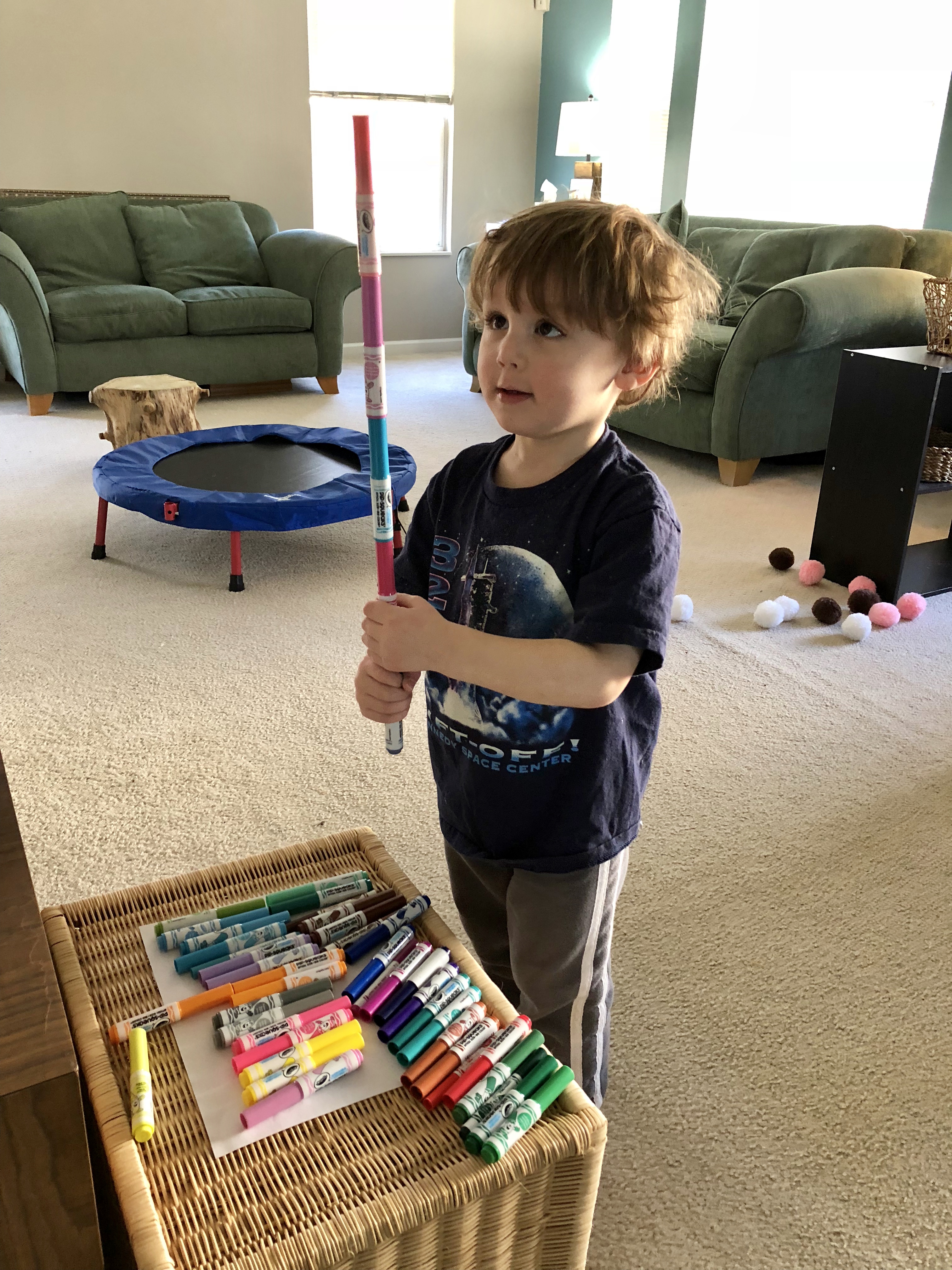 boy holding up a marker tower