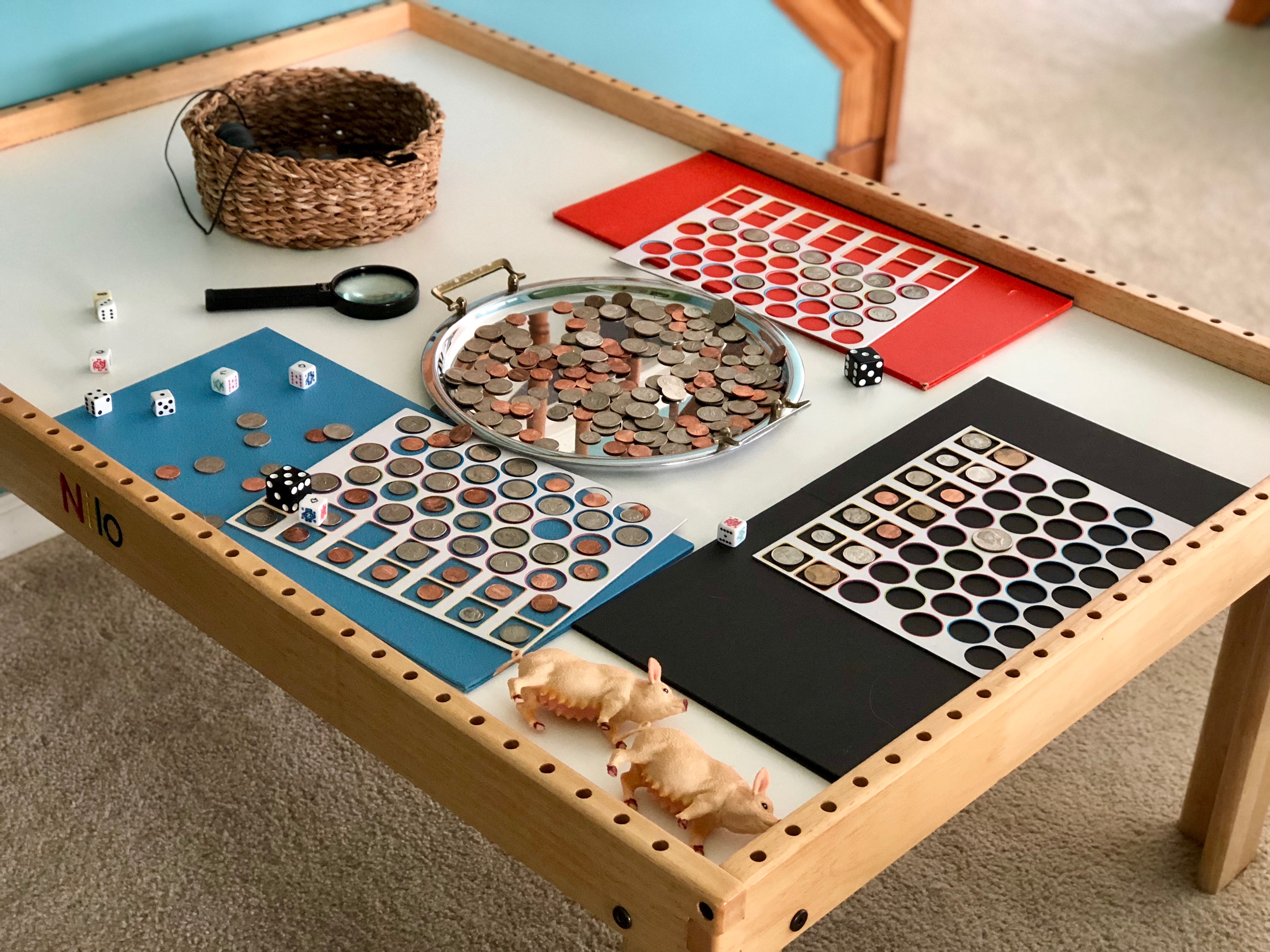 girl fitting coins into circular slots