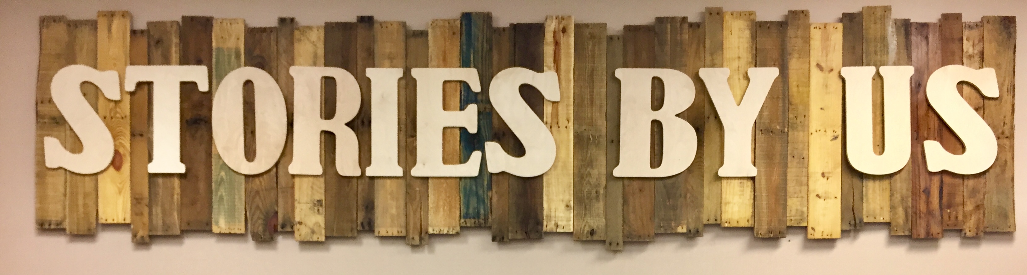 a sign that reads "stories by us"