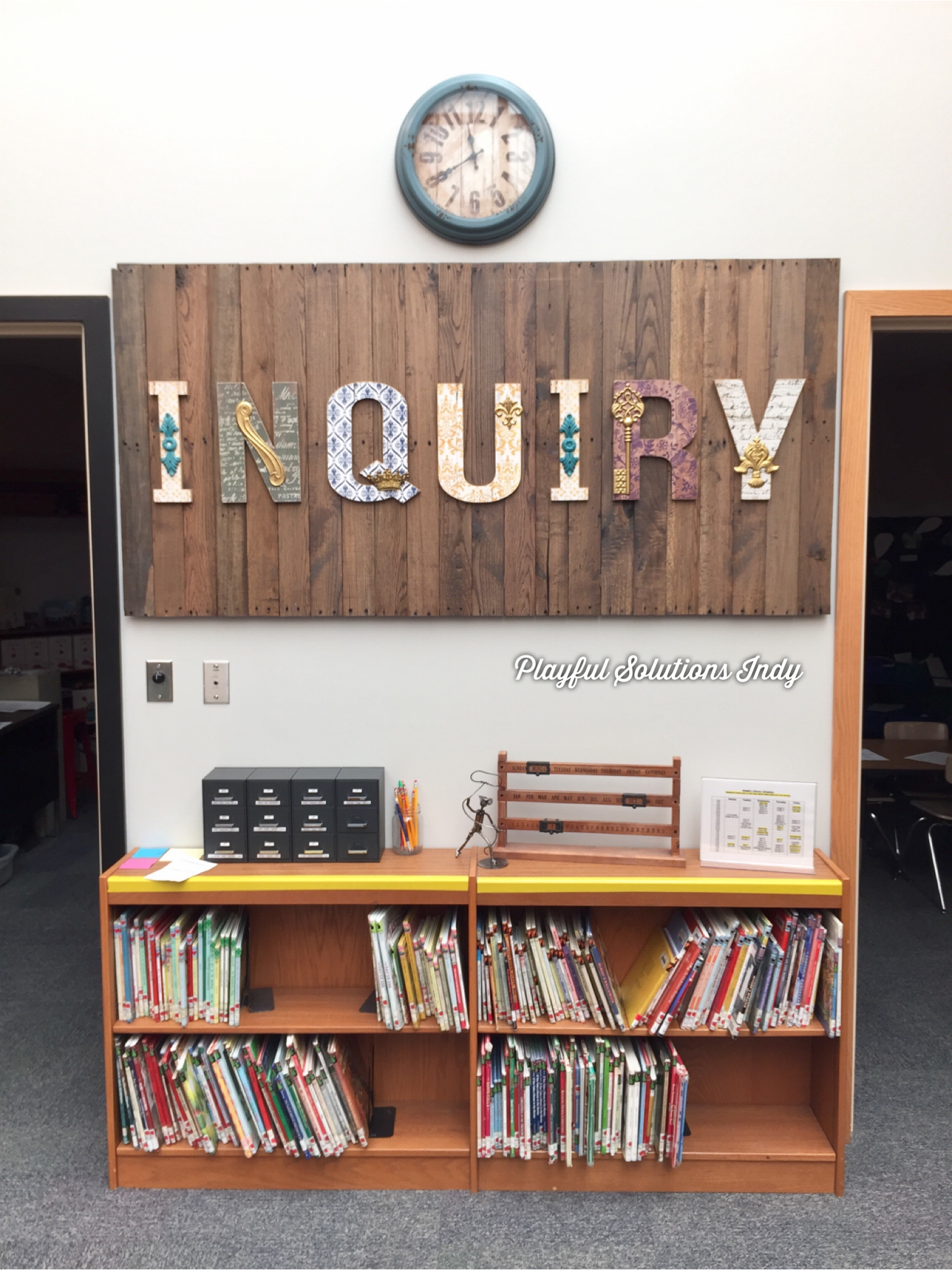 a large sign over a bookcase reading "Inquiry"