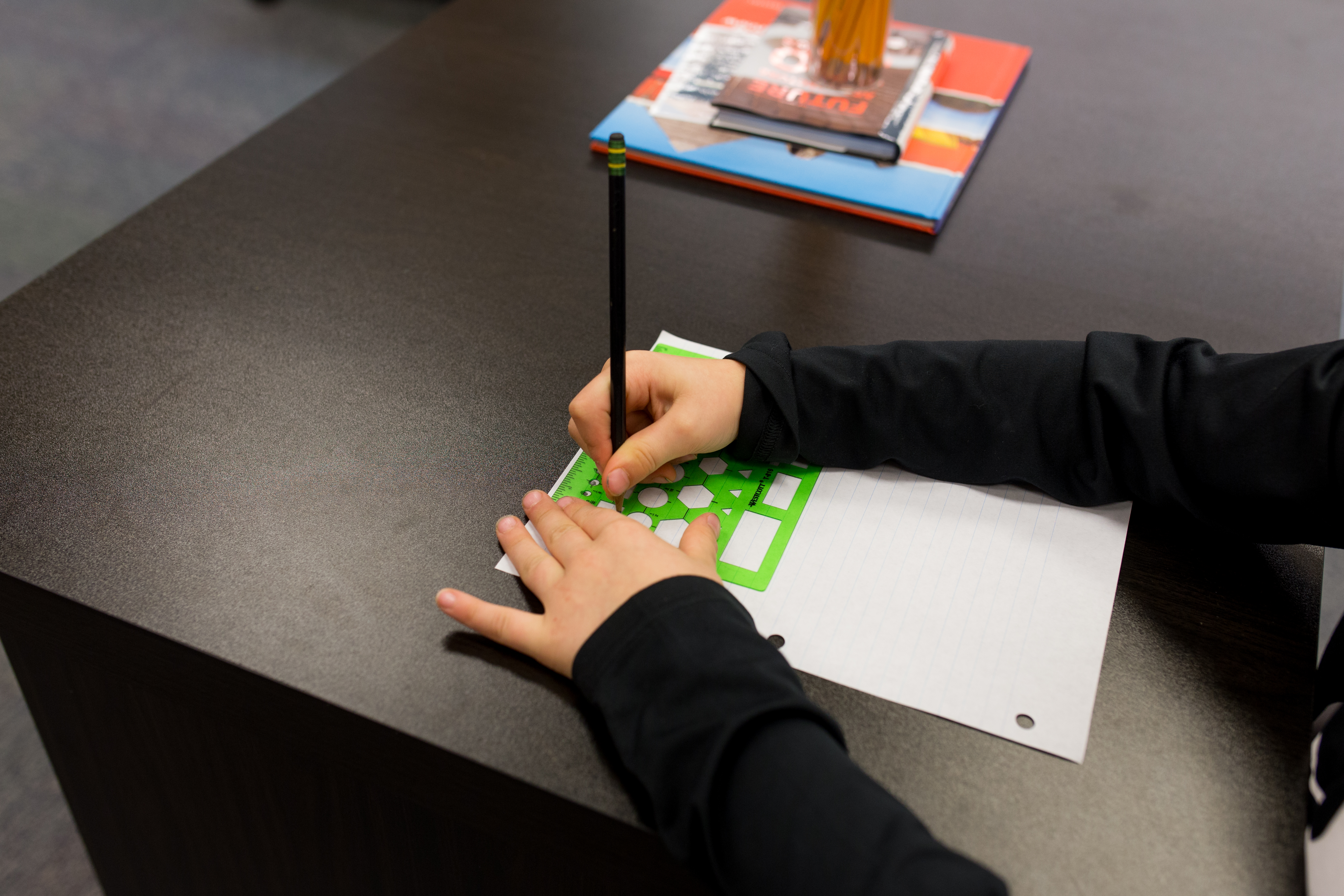 child using a shape stencil