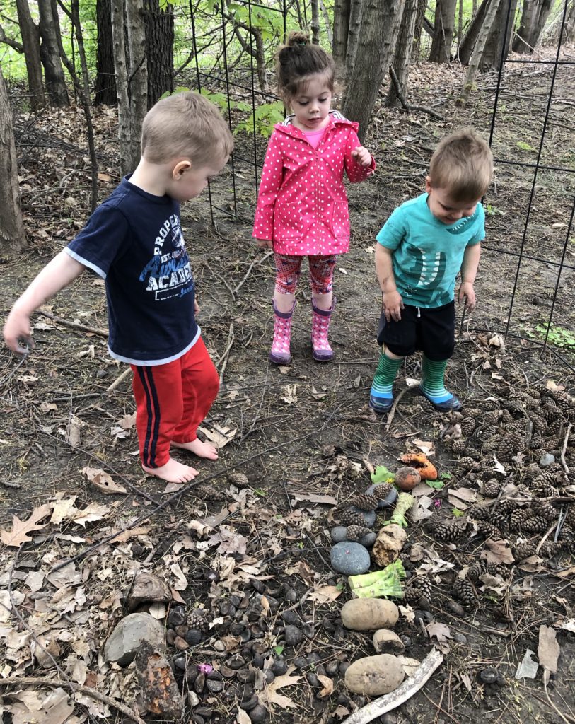 girl pointing out fruit flies to 2 boys