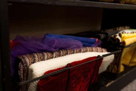 close up shot of various fabrics stored in wired baskets